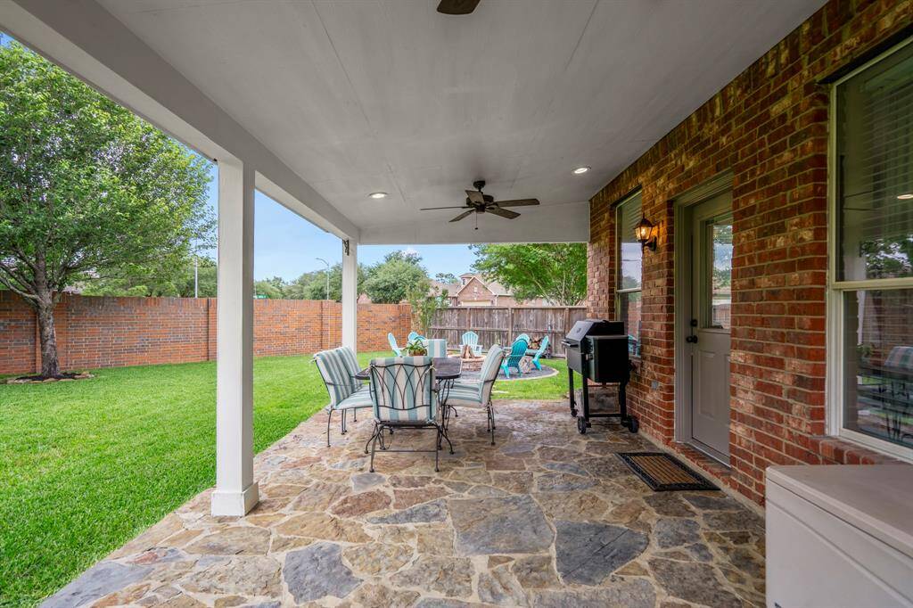 Step outdoors to the large covered backyard patio, with flagstone flooring, lighted outdoor ceiling fans. Simply a wonderful place to entertain!