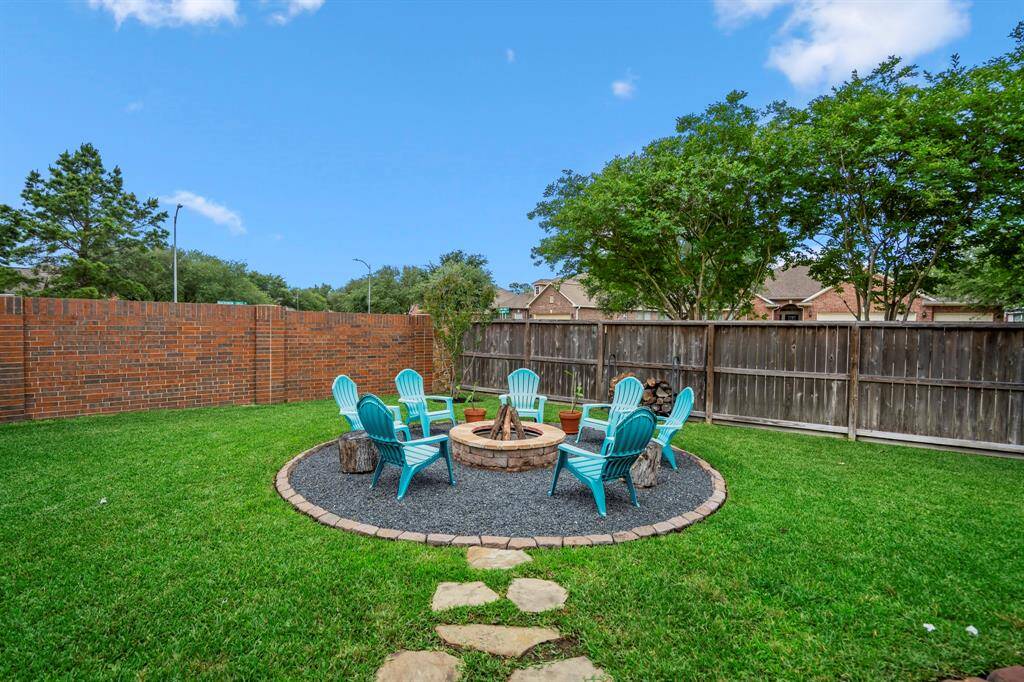 Invite friends over, and enjoy your amazingly beautiful backyard with firepit as well as fully fenced backyard that includes a brick fence.