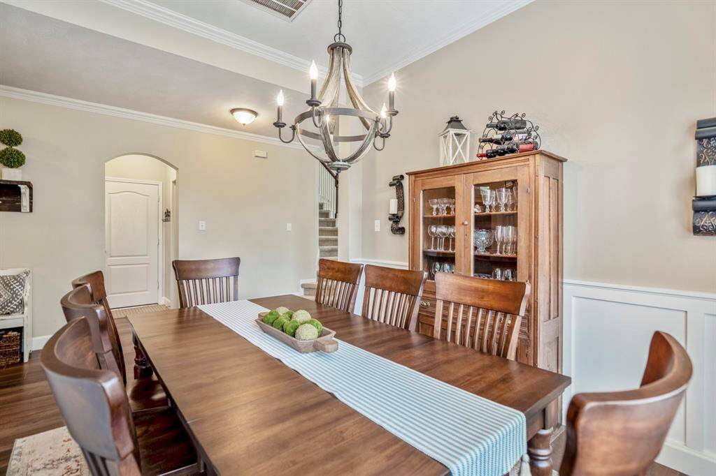 The large dining room offers plenty of space for a large table and other furniture, notice a wall panelling to elevate the elegance of the space.