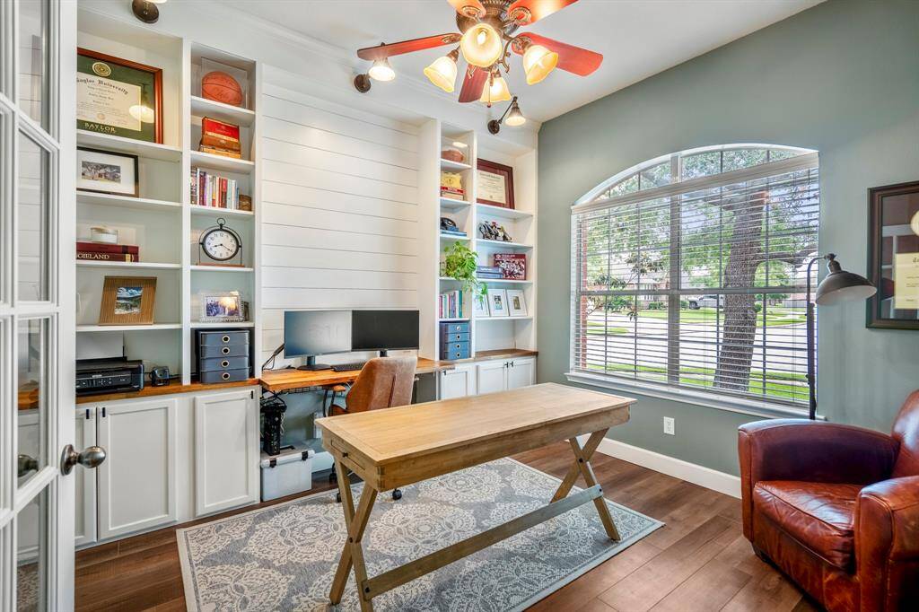 Conveniently located at the front of the home, you will find the study, which has custom built-ins, contrasting wooden table tops and built-in desk area.