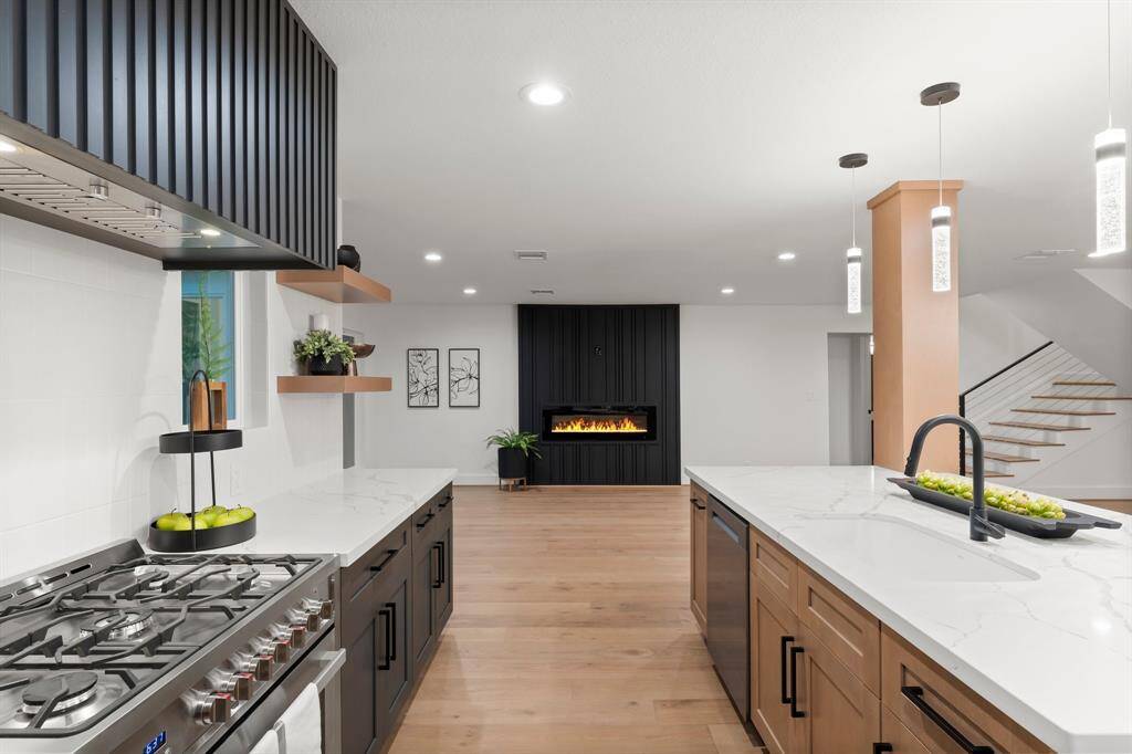 This home exudes high end designer finishes such as gorgeous quartz counters, modern linear cabinet hardware, and appealing lighting.