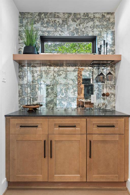 Custom dry wine bar (or coffee bar) has a sophisticated feel with cabinetry perfection, and upscale designer antiqued mirror from counter to ceiling is spectacular. Extra cabinets/drawers/counter space are always an appreciated feature, as well as a window for natural lighting.