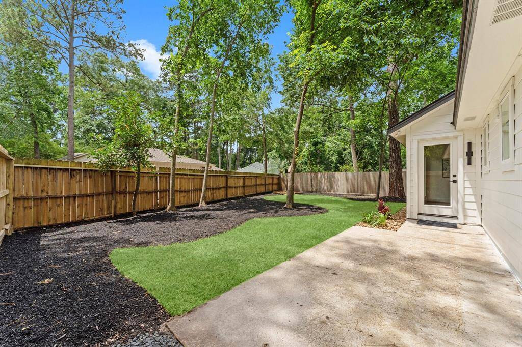New concrete, new fence, new sod and mulched beds.