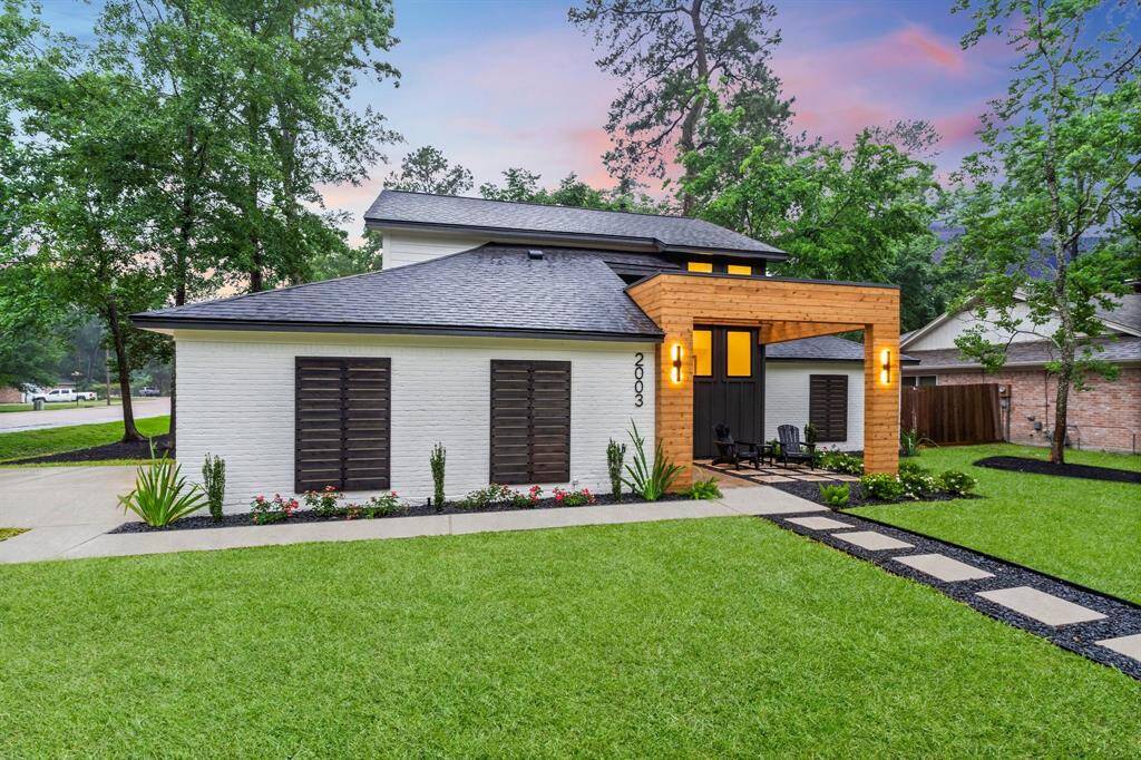 The setting is peaceful with surrounding greenery and a twilight sky.