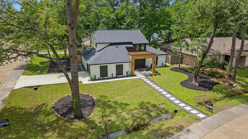 Aerial view of spacious corner homesite showcasing new landscaping, new pathway from street, along with new concrete driveway and new walkway in front of home.