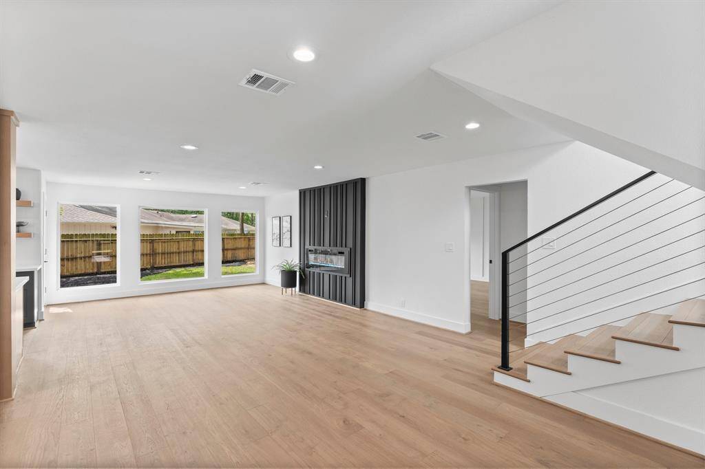As you enter this fabulous home there's an inviting open view of the living room and the wall of windows filling the room with natural light.