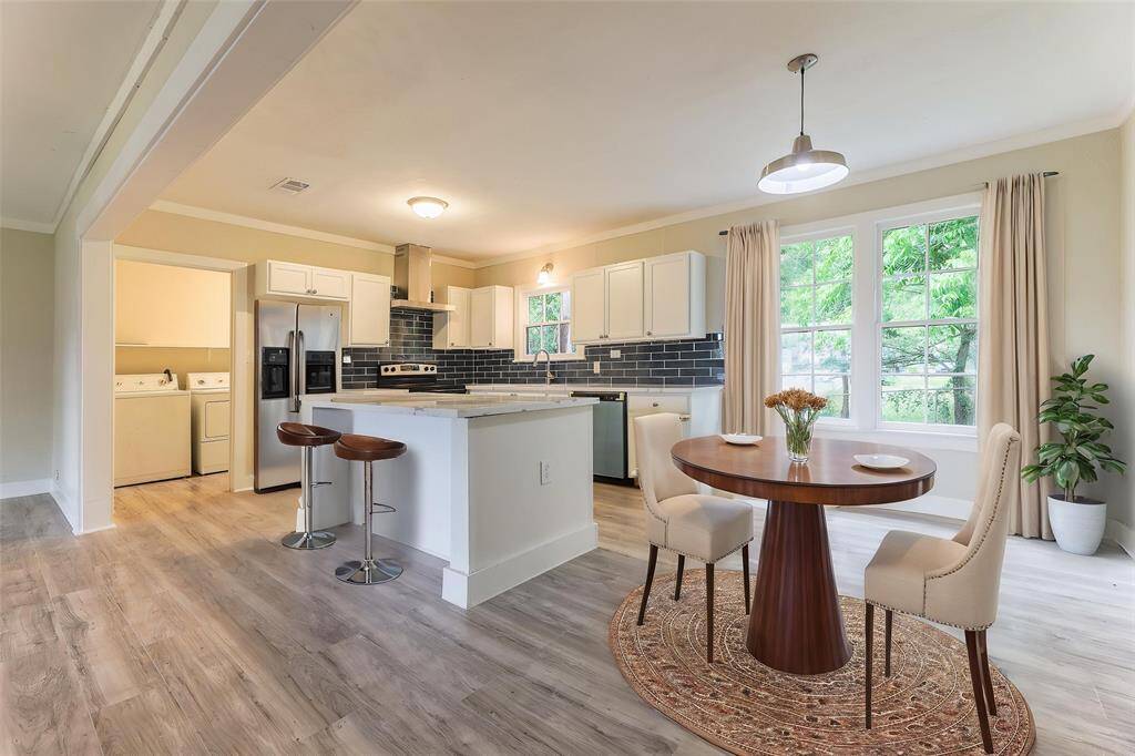 The open-concept living room seamlessly flows into the kitchen and dining area.This photo has been virtually staged.*This photo has been virtually staged.*