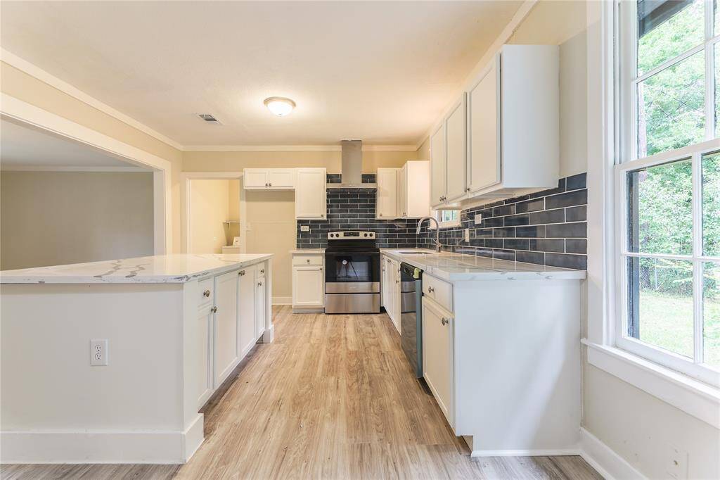 The kitchen features a centrally located island, perfect for meal prep and casual dining.