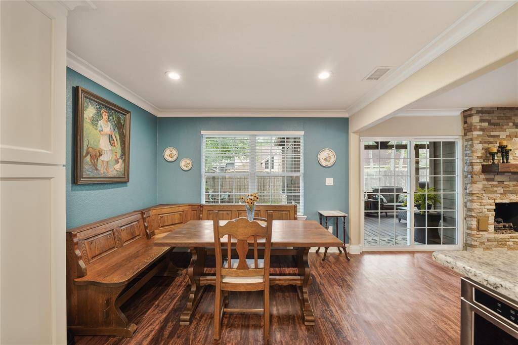 Elegant dining space with natural light, custom trim, and adjacent to kitchen.