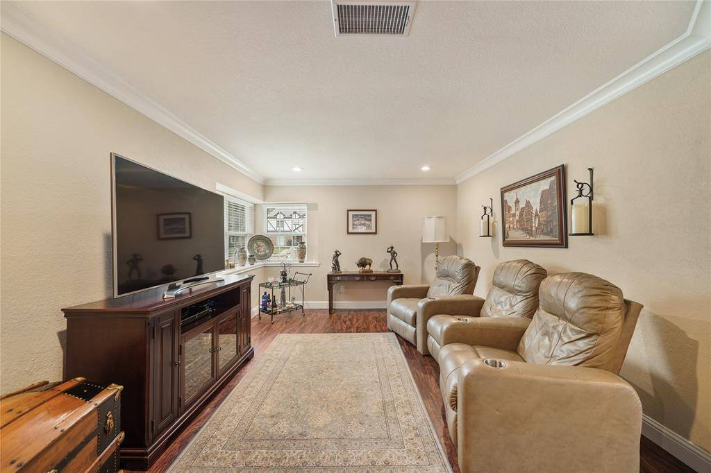Cozy family room with built-in cabinetry and media setup, ideal for relaxing or movie nights. CAN ALSO BE A GREAT HOME OFFICE OR DOUBLE AS A FORMAL DINING!