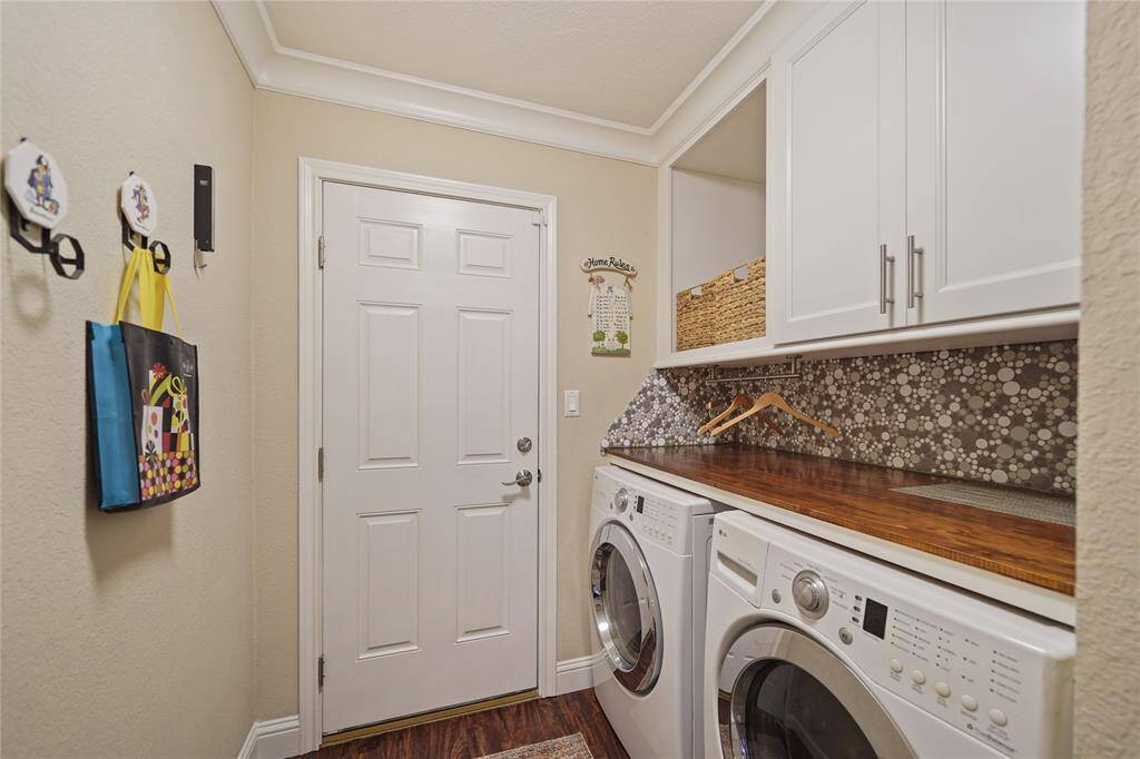 Utility room with storage cabinets, FULL counter, and washer/dryer connections. PLENTY OF SPACE!