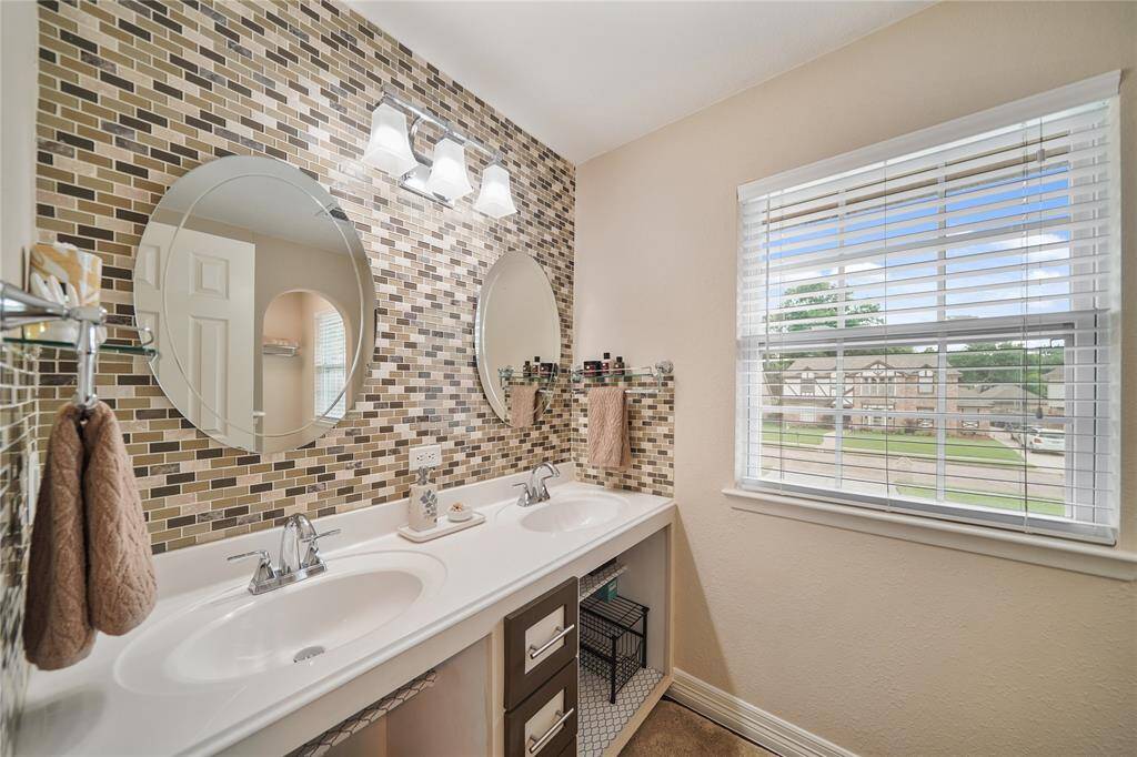 Stylish secondary bathroom with decorative tile wall, updated vanity, and great natural light. TUB/SHOWER COMBO