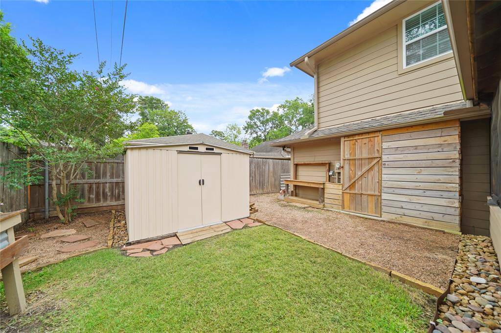 Backyard area includes a storage shed and privacy fencing AND SOME GREAT LANDSCAPING!