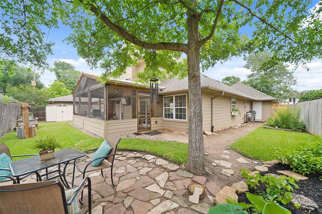 Tranquil stone patio shaded by mature trees—great for outdoor dining and gatherings. IMAGINE SIPPING THAT CUP OF COFFEE IN THE MORNINGS HERE!