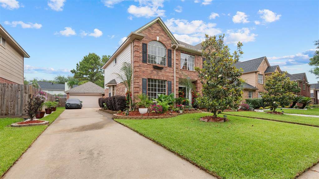 long driveway leading to detached garage / workshop