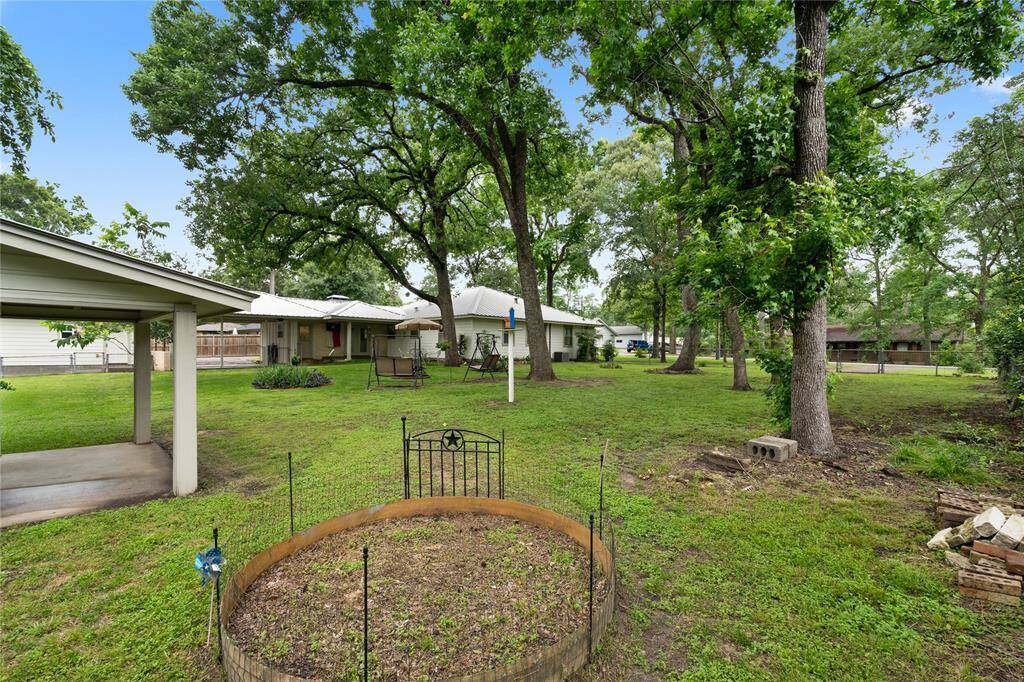Back Yard featuring Garden Beds, Flower Beds and plenty of space to run!