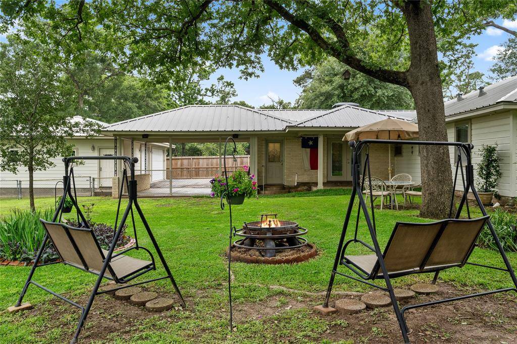 Sitting Area in Back Yard with a Custom Fire Pit! Covered Back Porch Door.