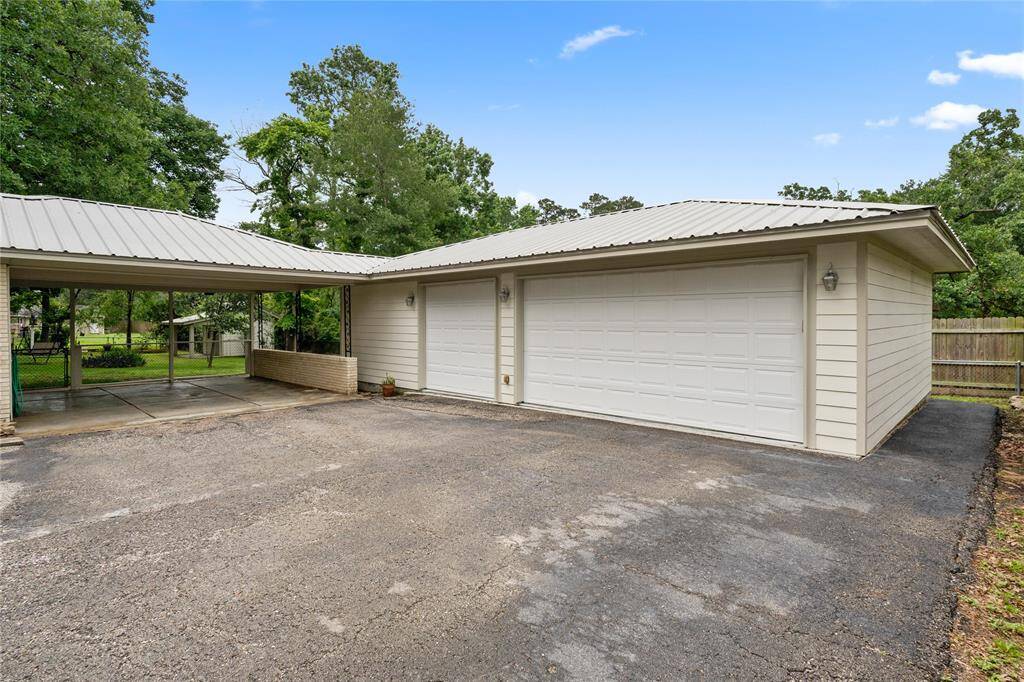 3 Car Garage and 2 Car Car Port, notice the Metal Roof