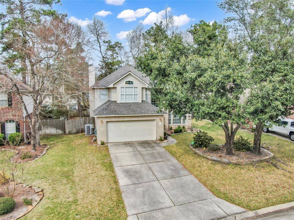 Charming two-story home with a welcoming driveway and attached garage.