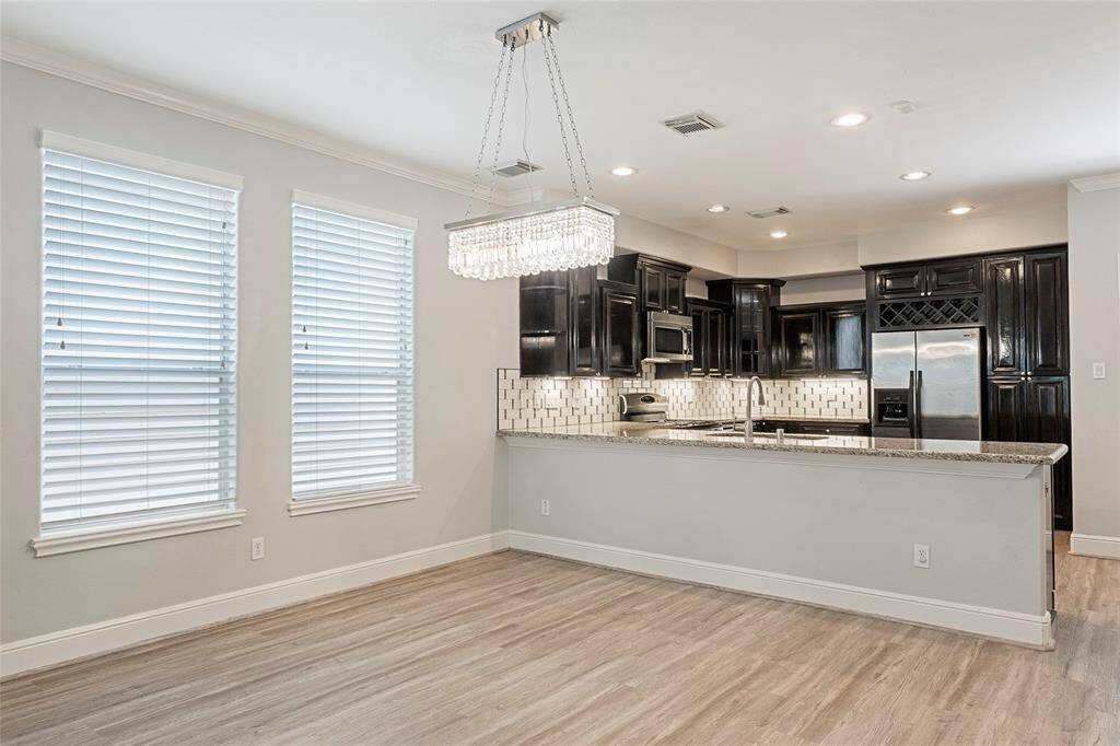 Dining room features upgraded lighting and plenty of natural light