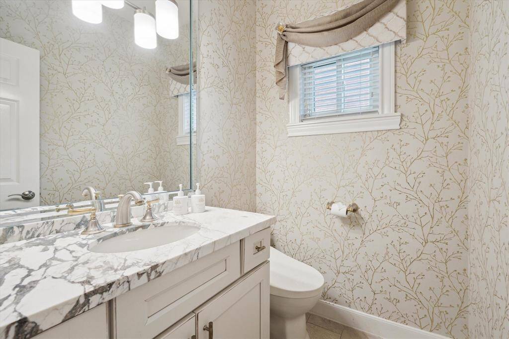 Updated powder room with attractive quartz counter tops.