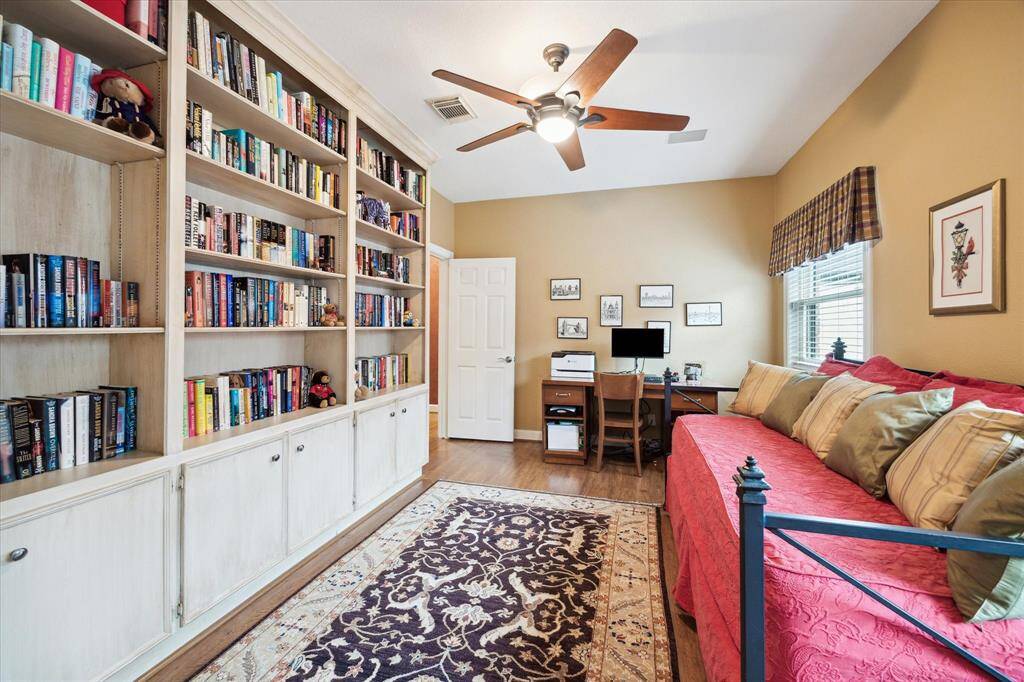 Upstairs bedroom with built-in bookshelves & cabinets.
