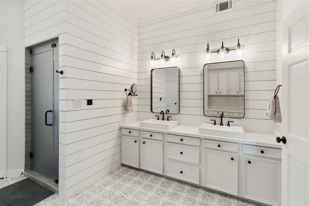 Your primary bathroom has been completely renovated and well thought out with double vanities, a sauna shower and separate tub area.