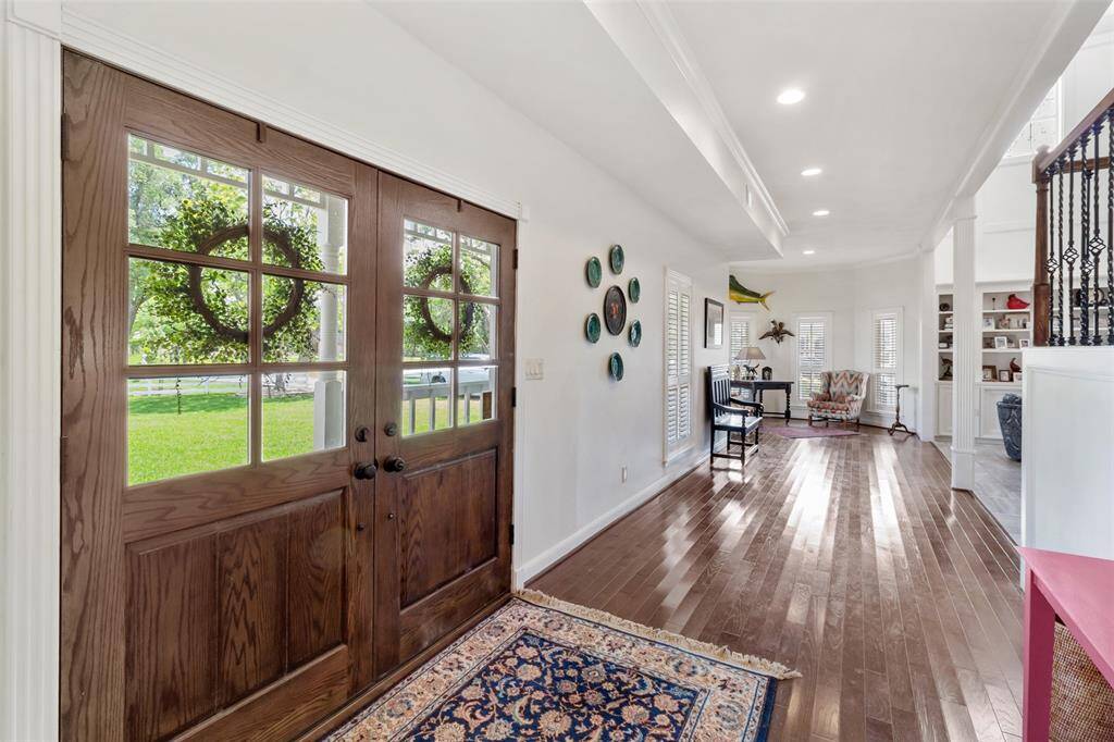 As you enter through the double front doors you are greeted by gorgeous floors and a grand hallway leading you to additional seating.