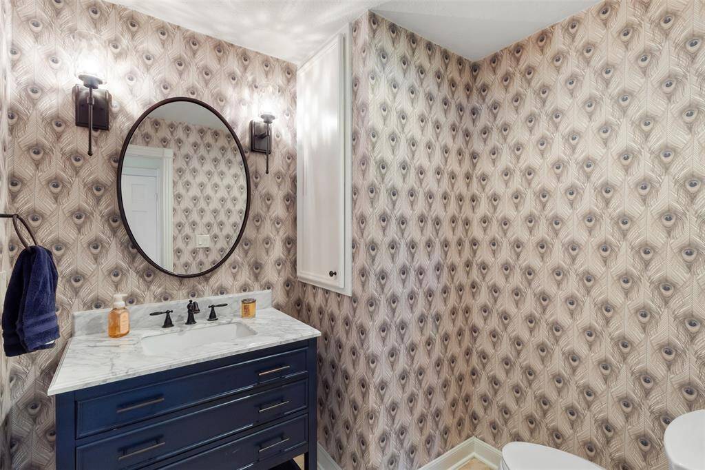 This 1/2 bath with designer finishes is located just inside the from doors and outside is the additional bedroom.