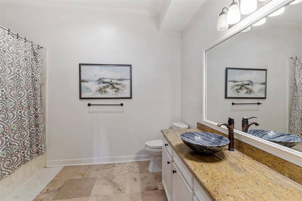 This en-suite bathroom has plenty of space and a large closet.