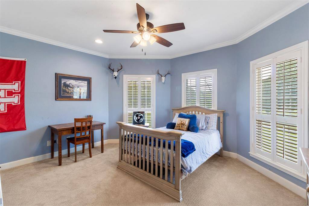 Another secondary spacious bedroom is at the top of the stairs.