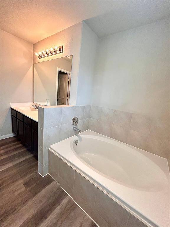 Large primary bathroom with private latrine area, double vanity and sinks, great lighting and large tub for two!