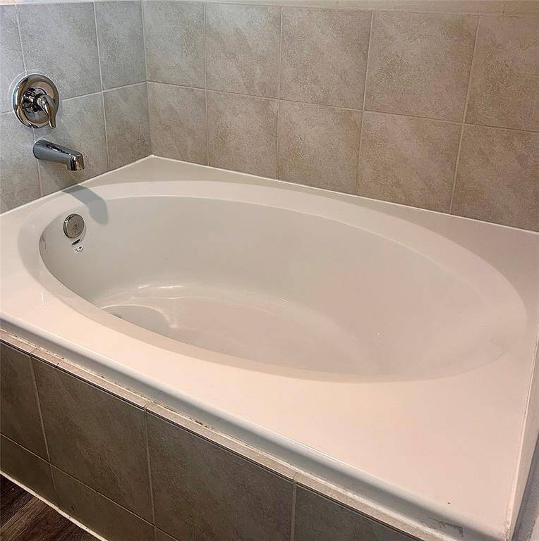 Enjoy soaking in this clean looking new garden tub enriched with natural lighting for possible plants!