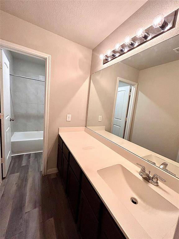 Private restroom with two doors and vanity area. Great lighting!