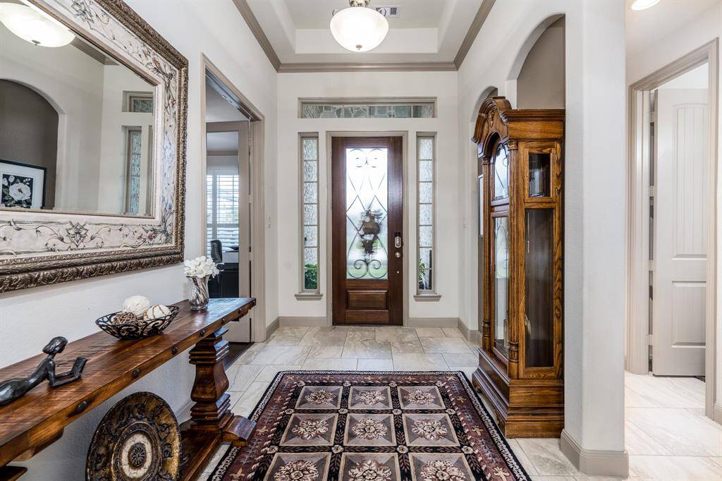 The entryway has a 12 foot tray ceiling with crown molding.  The office entry is on the left, and the door to the right is the full bath between bedrooms 2 and 3.