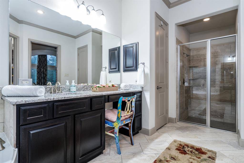 There's a make-up niche, linen closet, and the shower is large with multiple wall shelves and a bench.