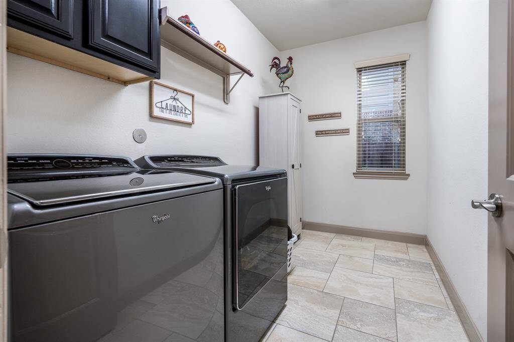 Large utility room with hook ups and space for a second fridge.
