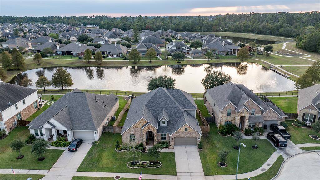 This could be your new home!  Beautiful elevation with lush landscaping and uplighting on a cul-de-sac backing up to one of the neighborhood lakes, fountain, and walking trails! Home is in the center which is the entrance to the cul-de-sac.  Look at that beautiful view!  It backs up to one of the many lakes and walking trails.