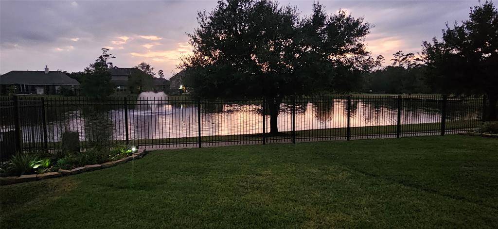 View from the back patio at dusk showing the lake and walking trail right before the fountain light comes on.