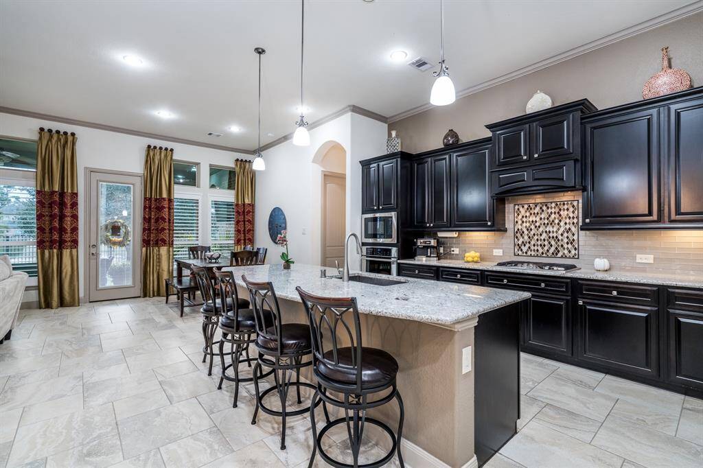 The kitchen is spacious and open, with granite counter tops, an abundance of cabinets, and seating at the bar.  Prepare a meal and enjoy conversing and socializing with friends and family!