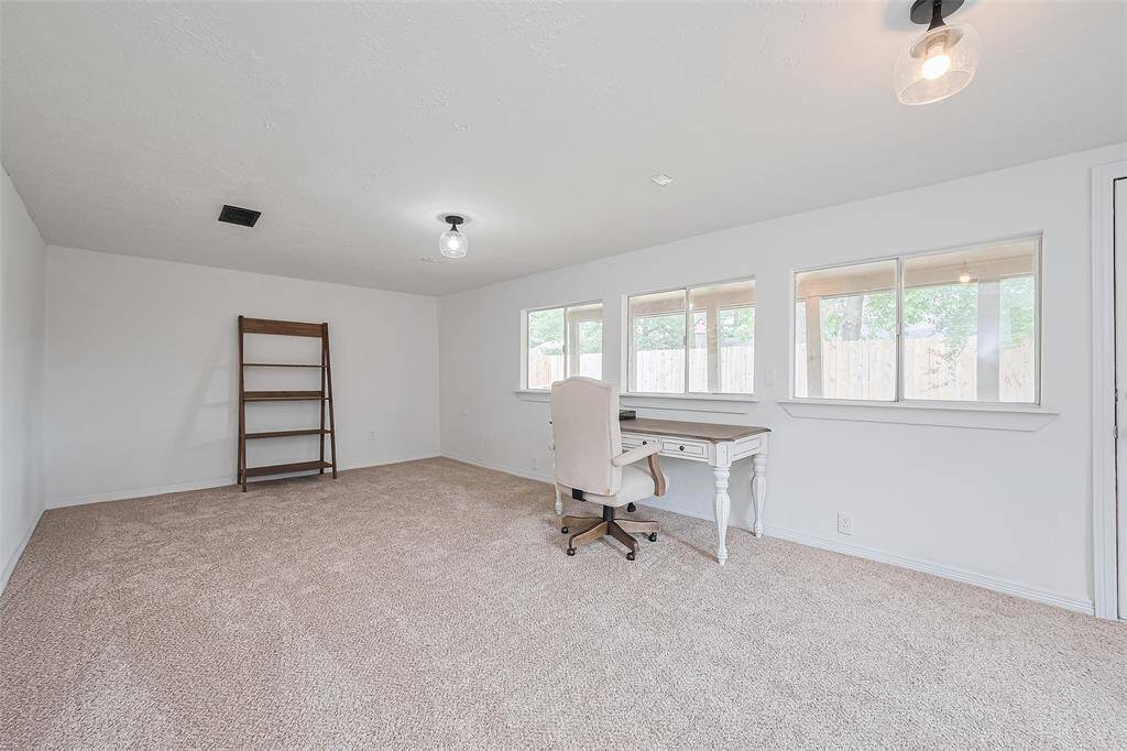 wall of windows to back yard brings lots of light to the extra living space.
