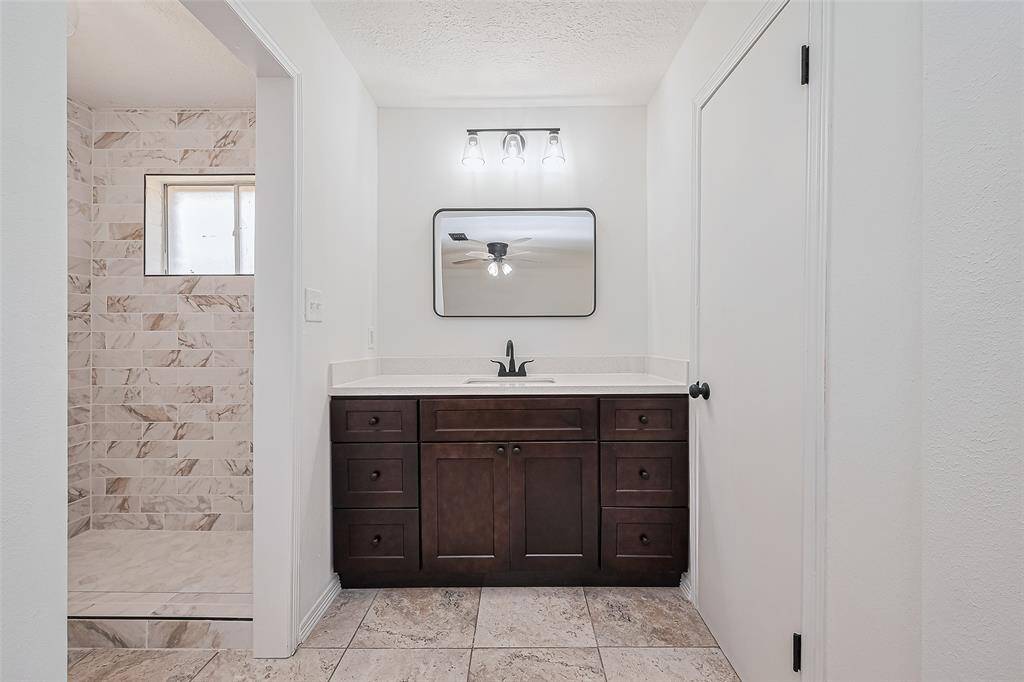 Primary bath , new tile in shower, the Modern upgrade has a spa like feeling .