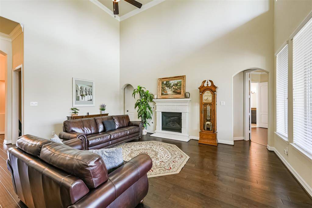 Another view of the Living Area which is grand in size and accented by a stone fireplace complete with gas logs.