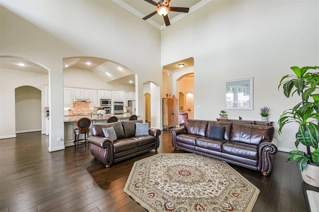 This view shows how open and free flowing this floor plan is.  Great for entertaining!  Notice the high ceilings, arches and the barrel ceiling in the kitchen over the island.