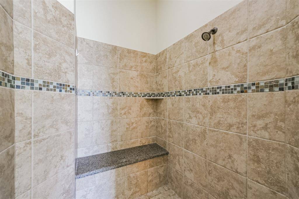 And if space is what you are looking for, just take a look at the size of this shower!  Notice the granite seating and decorative tile accents.