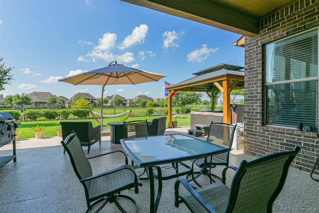 If you access the Patio from the Primary Bedroom, you find a partially covered area and around the corner is the pergola and hot tub.
