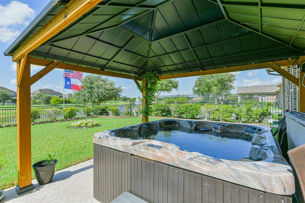 A closer view of the hot tub and pergola.  Imagine enjoying the soothing waters while sipping your favorite beverage and enjoying a view of the lake at sunset.