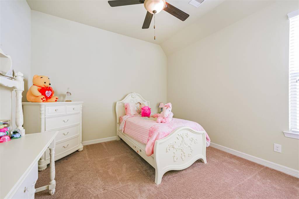 Secondary Bedroom located in another wing of the home. This bedroom shares a Hollywood bath with another large bedroom and has a large walk-in closet.