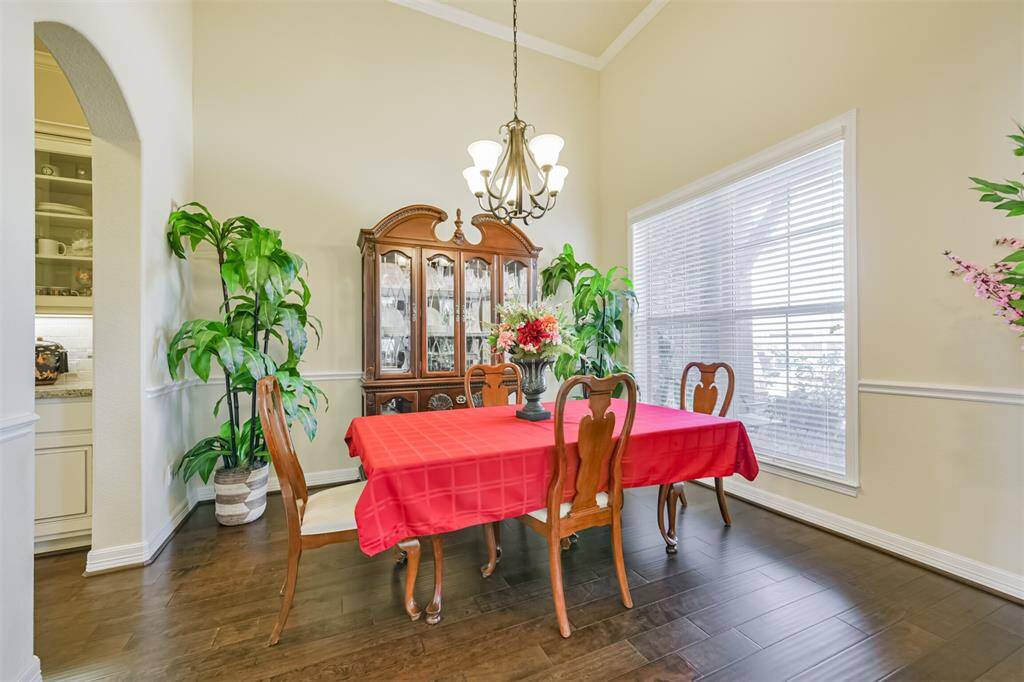 The Formal Dining Room also features hardwoods and is open to the Butler’s Pantry, Bar area and finally the Kitchen/Breakfast rooms.