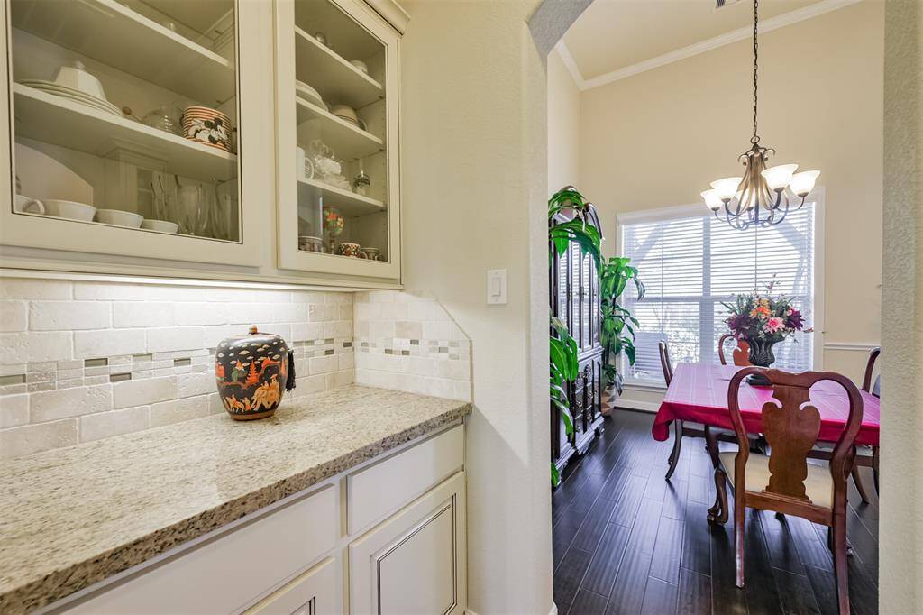 A closer view of the Butler's Pantry where you can display your collectibles behind glass doors. Plenty of storage room here. Notice the white cabinets and coordinated granite.